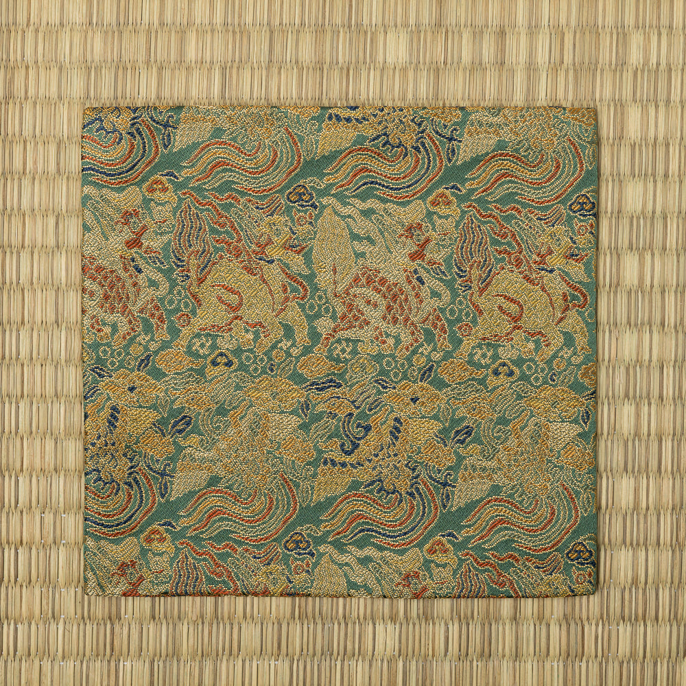 Full view of the moegi-green kobukusa featuring repeating kirin, phoenix, cloud, and gold-foil woven motifs.