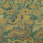 Close-up of the Nishijin silk brocade showing gold kirin and phoenix motifs among flowing multicolored clouds.