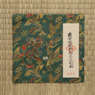 Japanese Nishijin silk kobukusa featuring dragon and phoenix motifs on a moegi green background