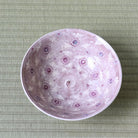 Top view of Morisato Touraku Hira Chawan showing delicate purple floral motifs across the pale interior
