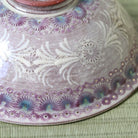 Close-up of the intricate white vine and floral Kyo-Mishima decoration on the deep purple Hira Chawan