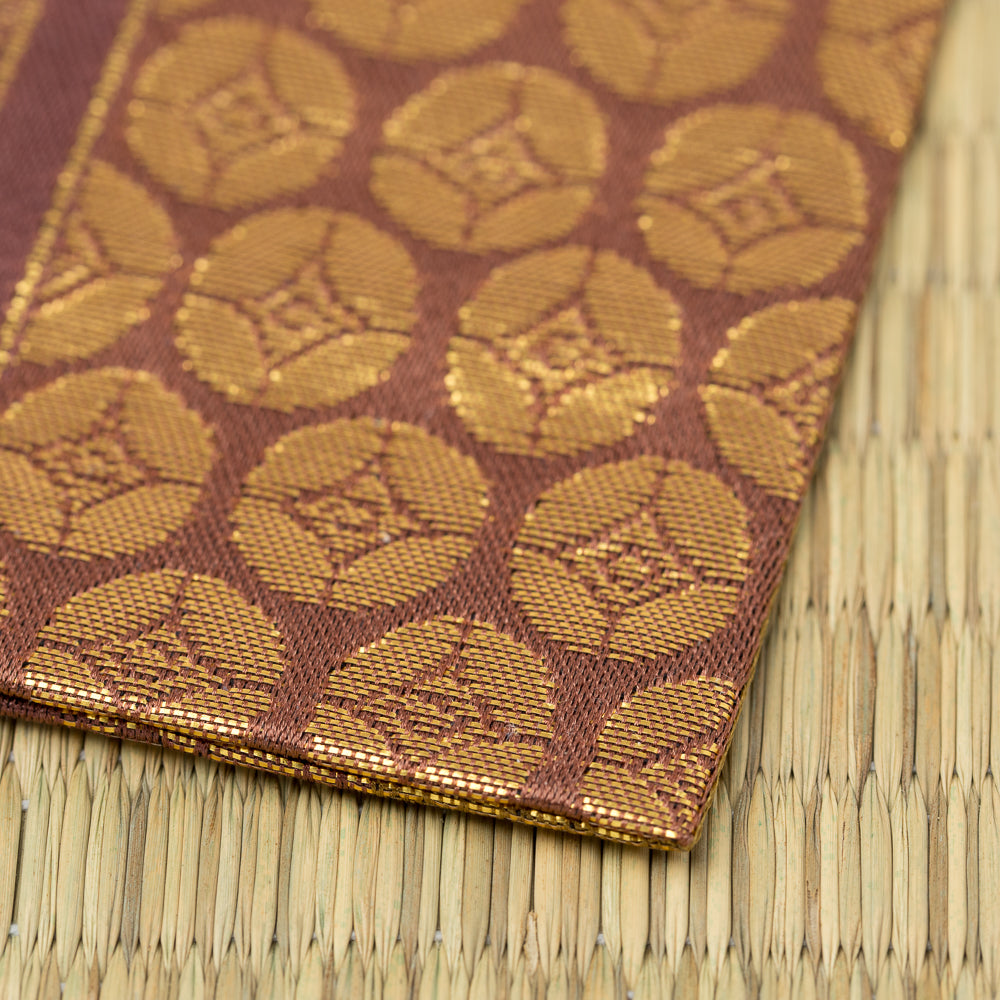 Close-up of the Nishijin silk weave and gold brocade detail of Murasaki Ji Osaka Shokkin Kinran Kobukusa.