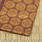 Close-up of the Nishijin silk weave and gold brocade detail of Murasaki Ji Osaka Shokkin Kinran Kobukusa.