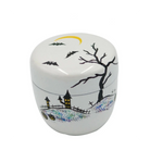 A white ceramic Halloween-themed lidded container with black illustrations of a bare tree, bats, a haunted house, and a yellow crescent moon, shown on a white background with Japanese text at the top.