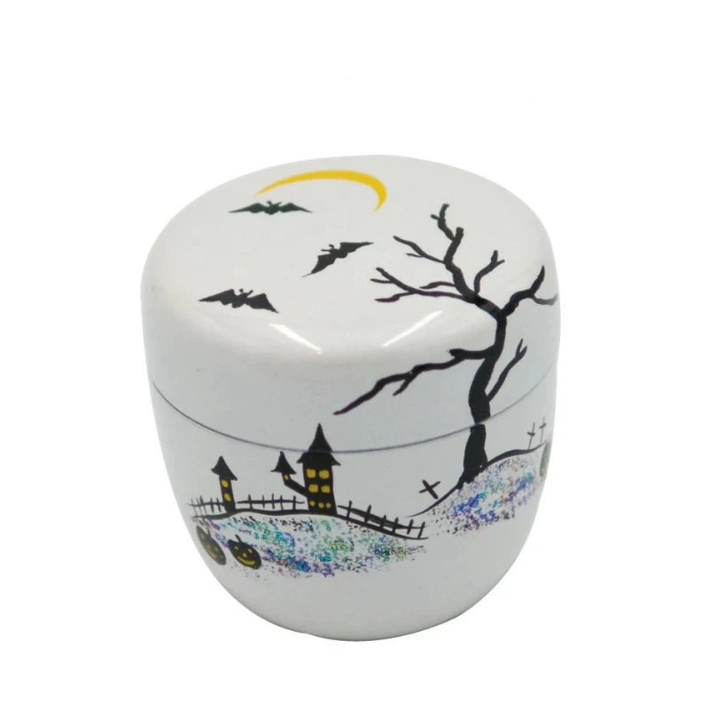 A white ceramic Halloween-themed lidded container with black illustrations of a bare tree, bats, a haunted house, and a yellow crescent moon, shown on a white background with Japanese text at the top.