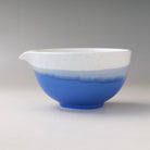 Left side profile of the Ocean Blue Mino Ware katakuchi matcha latte bowl showing its rounded form, pouring spout, and blue glazed exterior