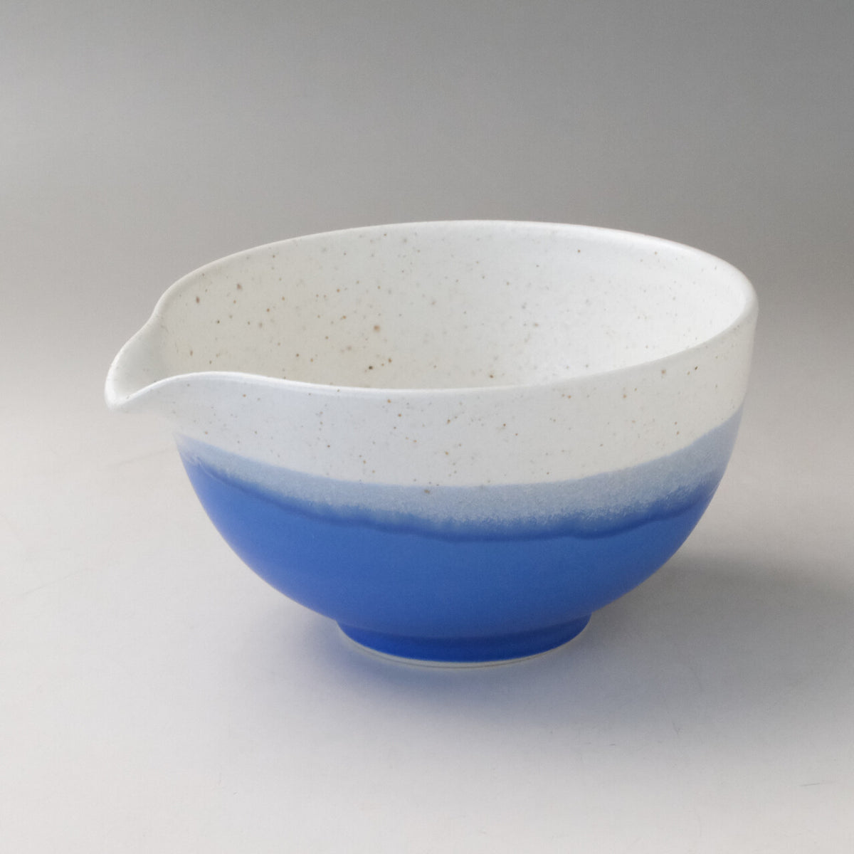 Ocean blue Mino Ware katakuchi matcha latte bowl with a white speckled glaze and pouring spout