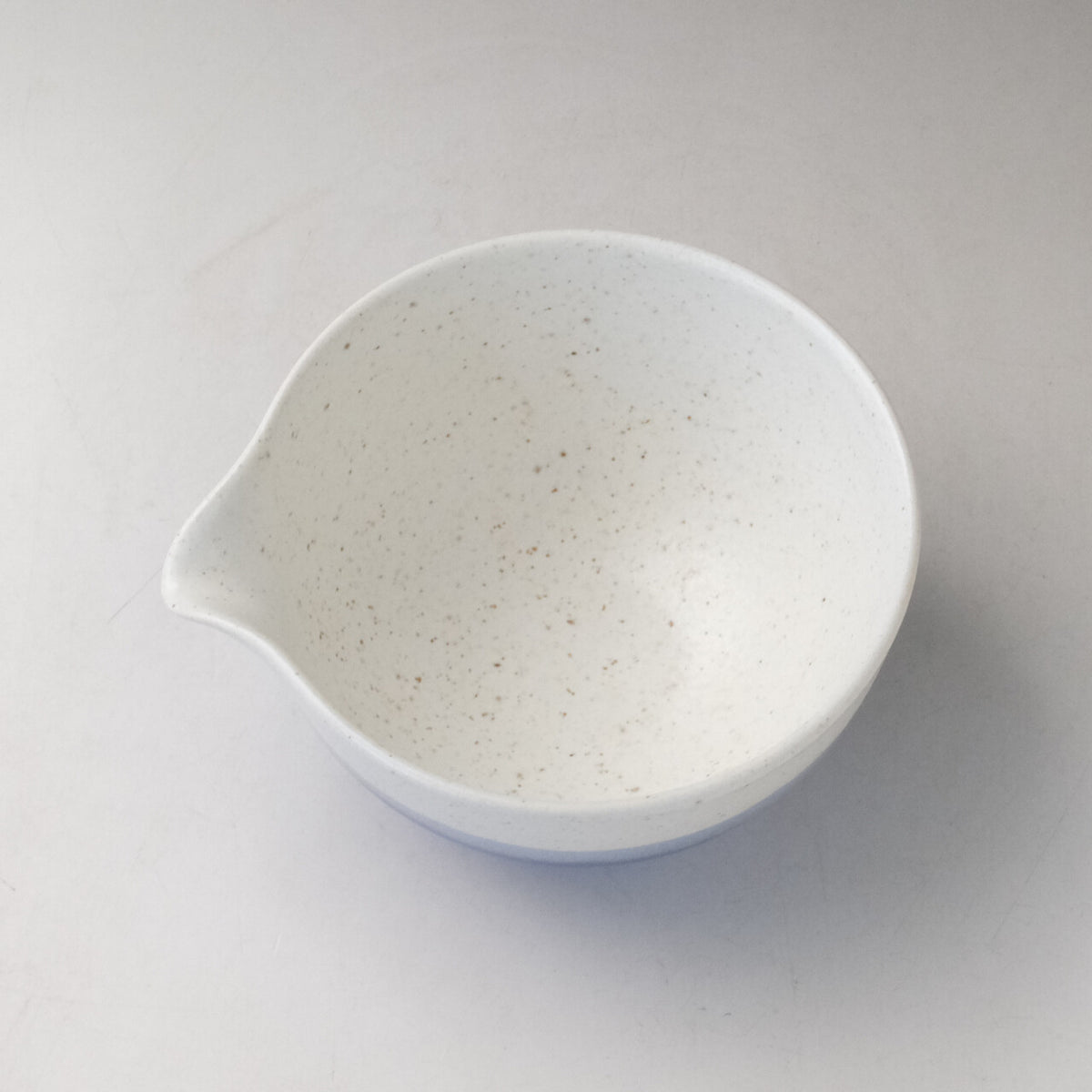 Top interior view of the Ocean Blue Mino Ware katakuchi matcha latte bowl showing the white speckled glaze and pouring spout