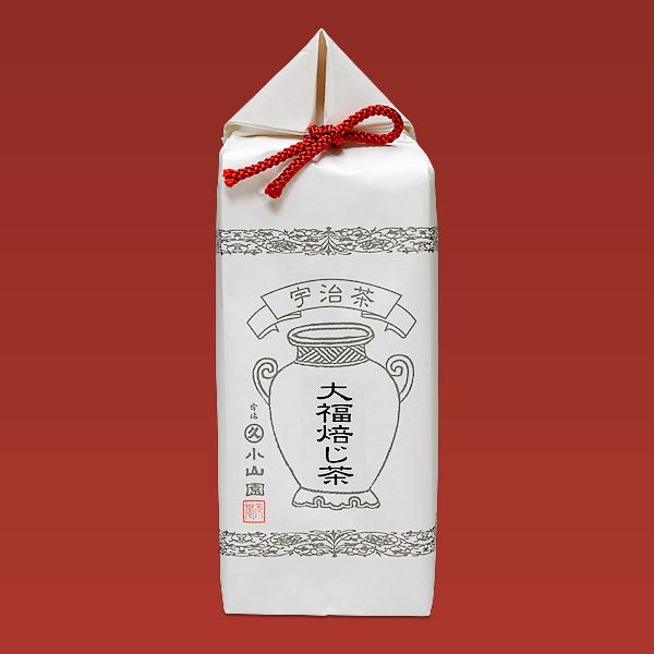White tea package with black design and red string on a red background