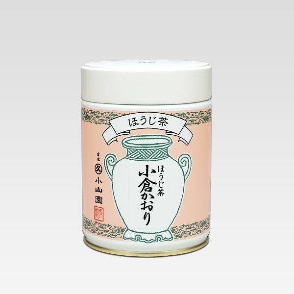 Tea canister with pink label and white lid on a light gray background