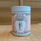 Tea canister with Japanese text and design on a woven mat background