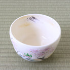 Angled top view of the spring landscape matcha bowl showing its white interior and hand-painted cherry blossom design around the exterior.