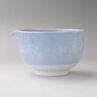 Side profile of the pale blue Mino Ware katakuchi matcha bowl showing its rounded shape, white foot, and soft cloudy finish.