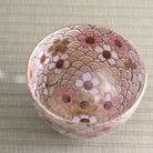 Top view of the peach blossom matcha bowl showing its richly decorated interior with pink blossoms and a detailed repeating background pattern.