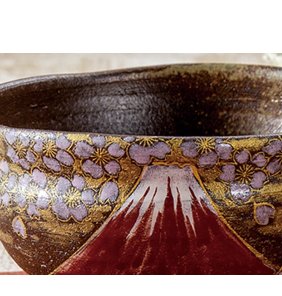 Detailed view of lavender and white cherry blossoms against gold leaf above Mount Fuji, with the dark brown glazed interior visible along the rim.