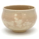 Back view of the matcha bowl showing its softly mottled beige glaze and gently rounded handcrafted form.