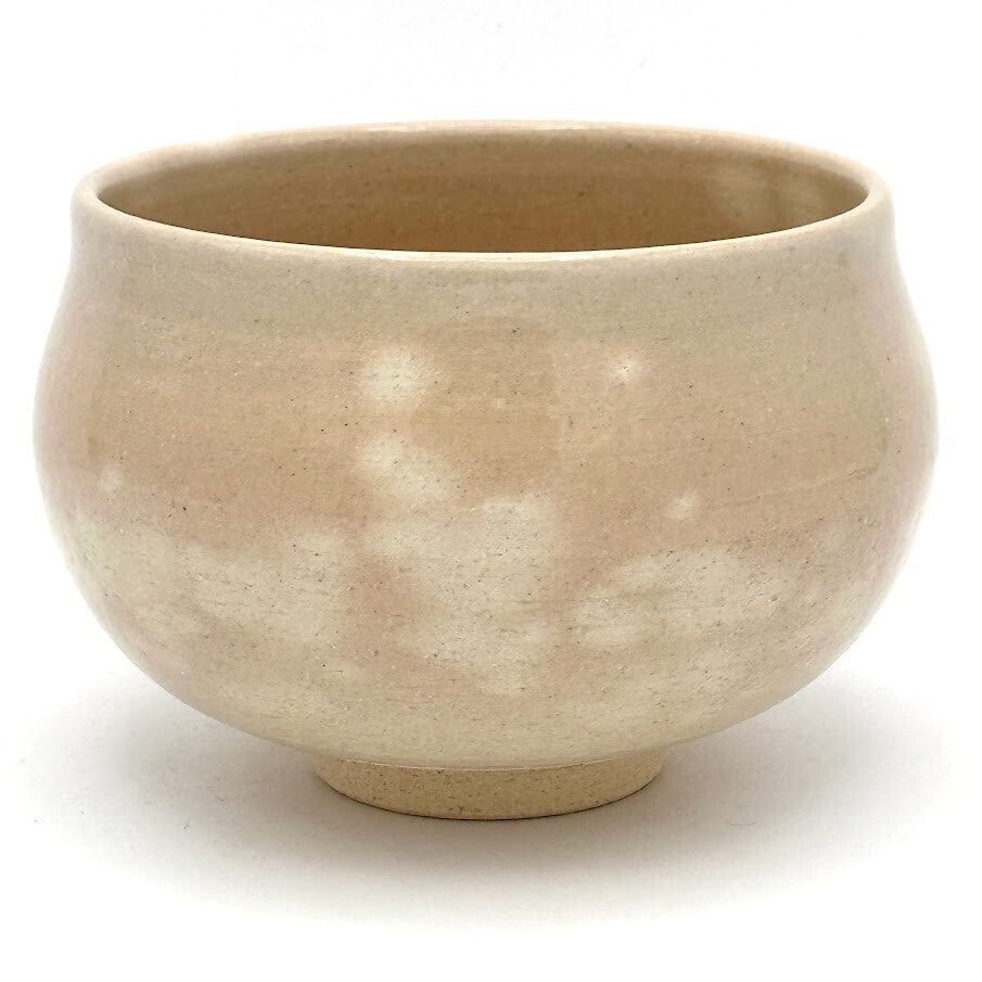 Back view of the matcha bowl showing its softly mottled beige glaze and gently rounded handcrafted form.