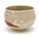 Left-side view of the hand-painted matcha bowl with scattered cherry blossoms and the Red Fuji design wrapping around the base.