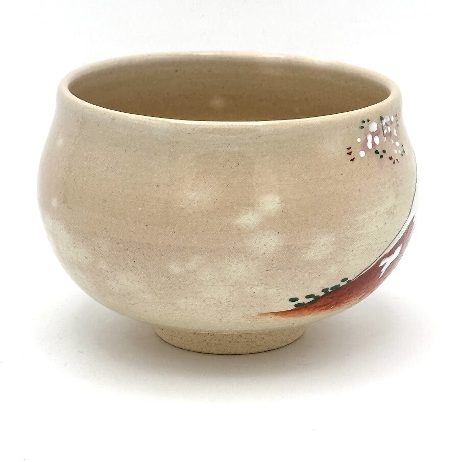Right-side view of the Kyo Ware matcha bowl with cherry blossoms near the rim and part of the painted Red Fuji landscape.