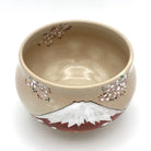 Top view of the Red Fuji matcha bowl showing its warm beige interior, cherry blossoms along the rim, and Mount Fuji on the exterior.