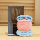 Black bamboo Takayama chasen by Ryosai Kubo displayed with Coral #3 thread and its presentation box