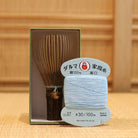 Black bamboo Takayama chasen by Ryosai Kubo displayed with Pale Blue #27 thread and its presentation box