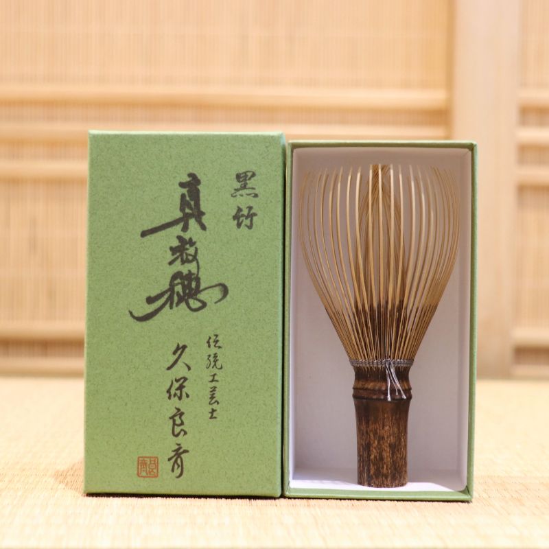 Ryosai Kubo handcrafted Takayama chasen made from Japanese black bamboo with Grey #37 thread, displayed beside its presentation box