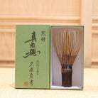 Ryosai Kubo handcrafted Takayama chasen made from Japanese black bamboo with Teal Blue #48 thread, displayed beside its presentation box