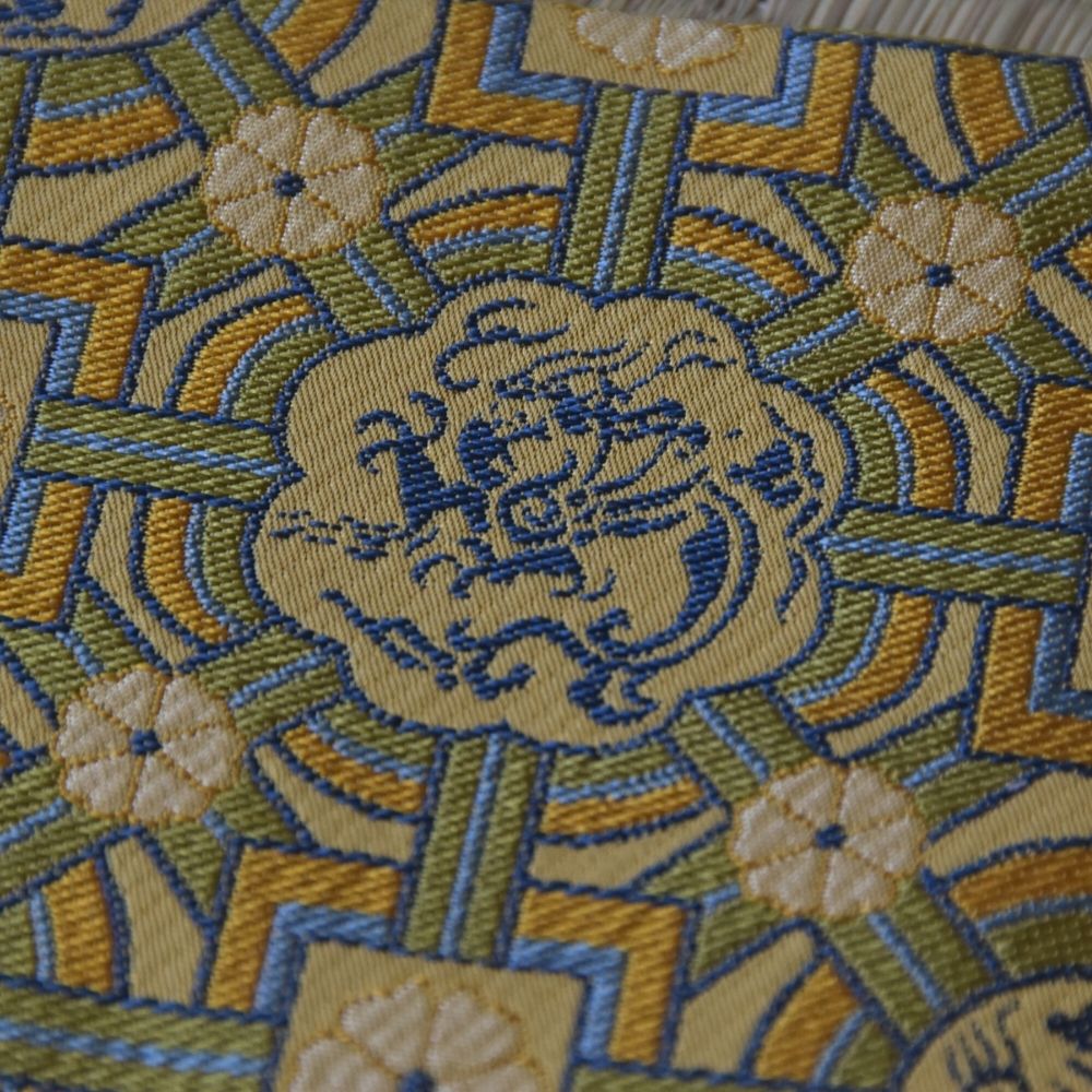 Close-up of dragon motif woven in traditional Nishijin silk brocade from Kyoto