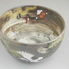 Angled top view showing the decorated interior of the Sakata Yahata matcha bowl, with cranes and plum blossoms continuing across the inner surface.