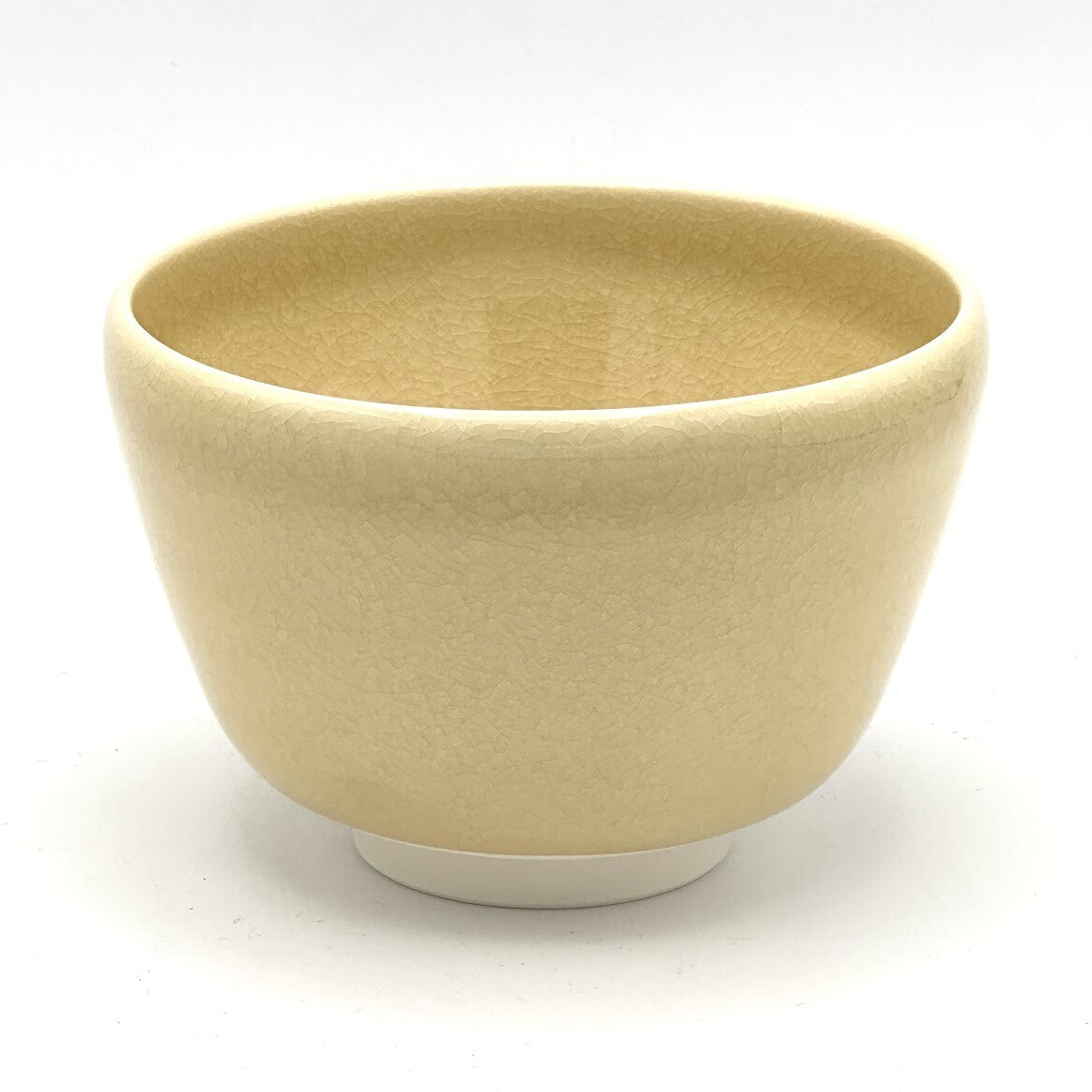 Back view of the matcha bowl showing its softly glazed beige surface and rounded handcrafted form.