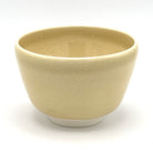 Back view of the matcha bowl showing its softly glazed beige surface and rounded handcrafted form.