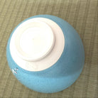 Blue and white ceramic bowl on a textured surface