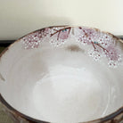 Ceramic bowl with decorative edge on a neutral background