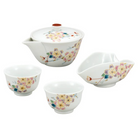 Set of ceramic tea bowls with floral patterns on a white background