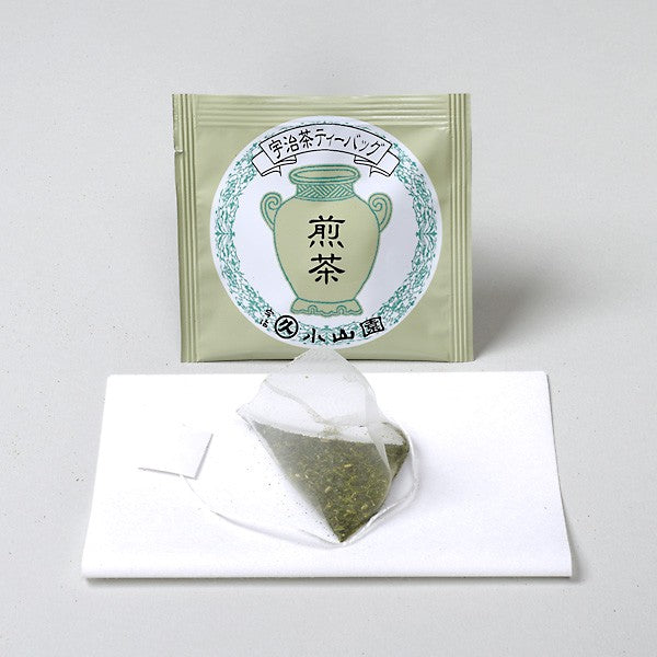 Tea bag packaging with a green label on a white background