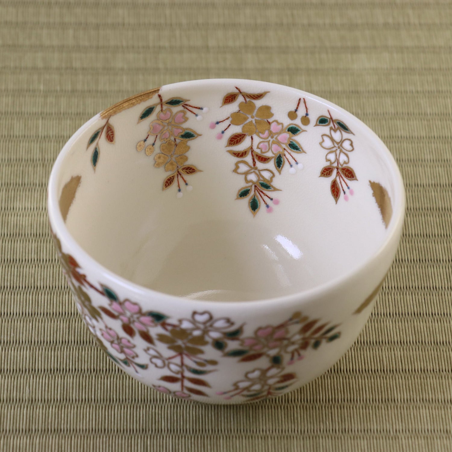 Decorative ceramic bowl with floral patterns on a textured surface
