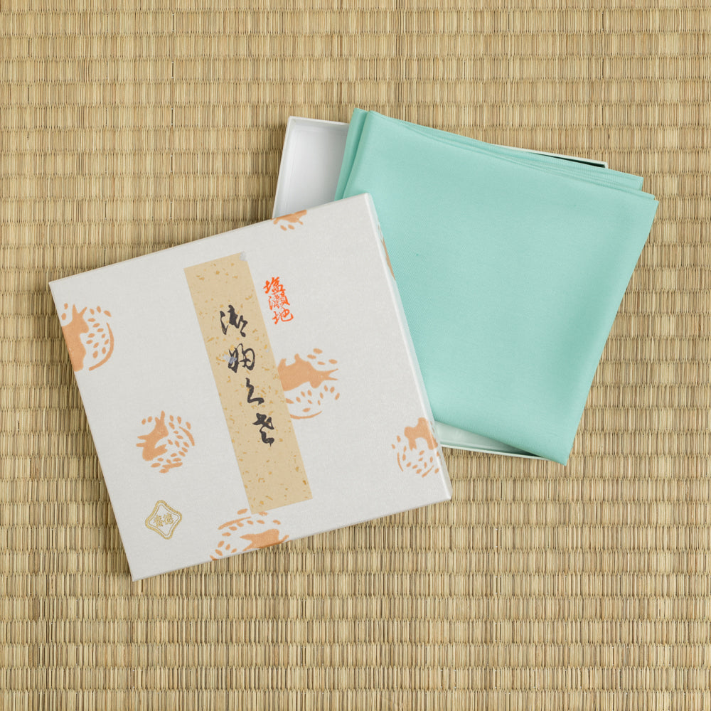 Mint green silk fukusa by Kitamura Tokusai with gift box on tatami for Japanese tea ceremony.