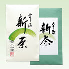 Two cards with black calligraphy on white and green backgrounds