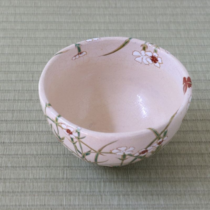 Top interior view of the Shisen Asano Nadeshiko matcha bowl showing its soft pale pink glaze and hand-decorated floral and grass motif around the rim
