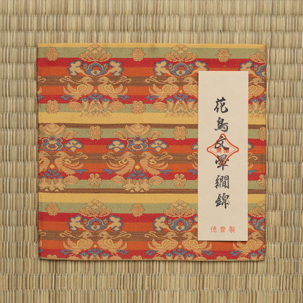 Shōsōin Kachōmon Ungen Nishiki silk kobukusa displayed on tatami with its paper title label.