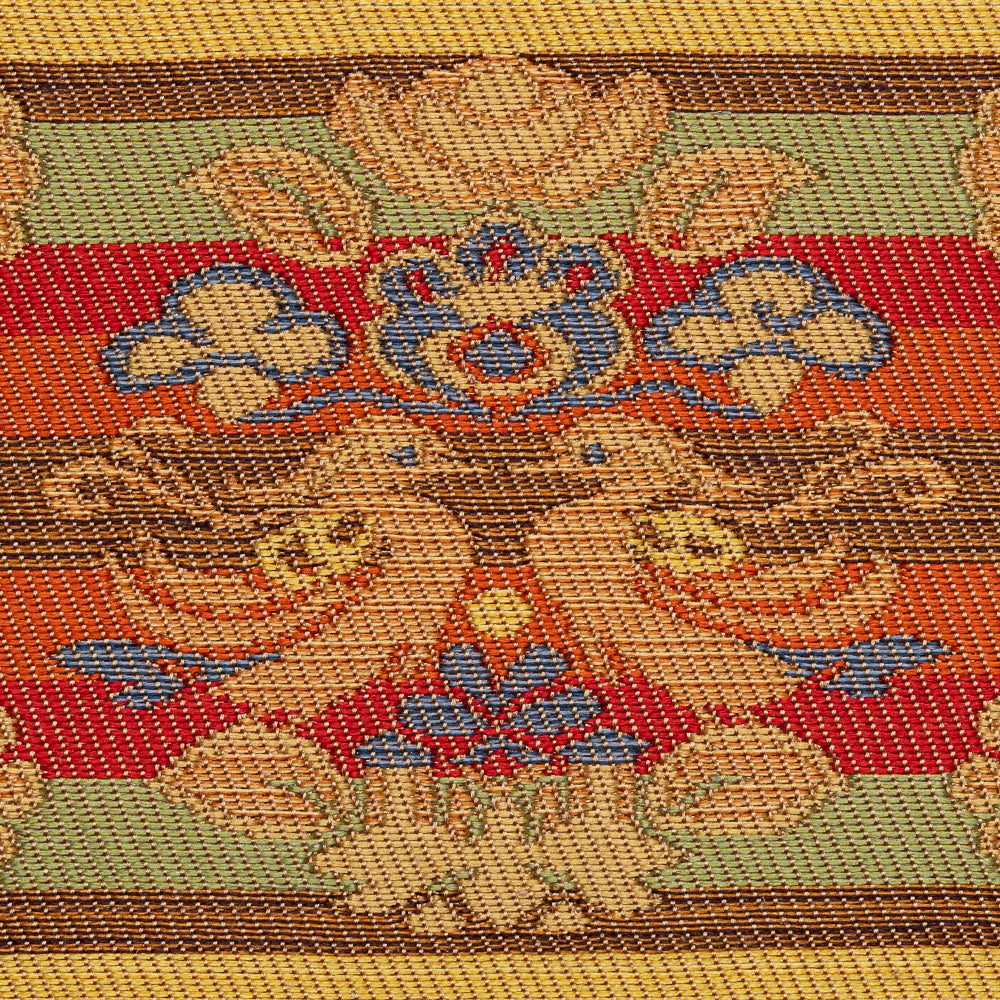 Close-up of the Nishijin silk brocade showing a stylized waterfowl, floral pedestal, and multicolored ungen weaving.