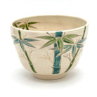 Hand-painted Kyo Ware matcha bowl with green and blue bamboo decoration and a refined gold foil accent along the rim
