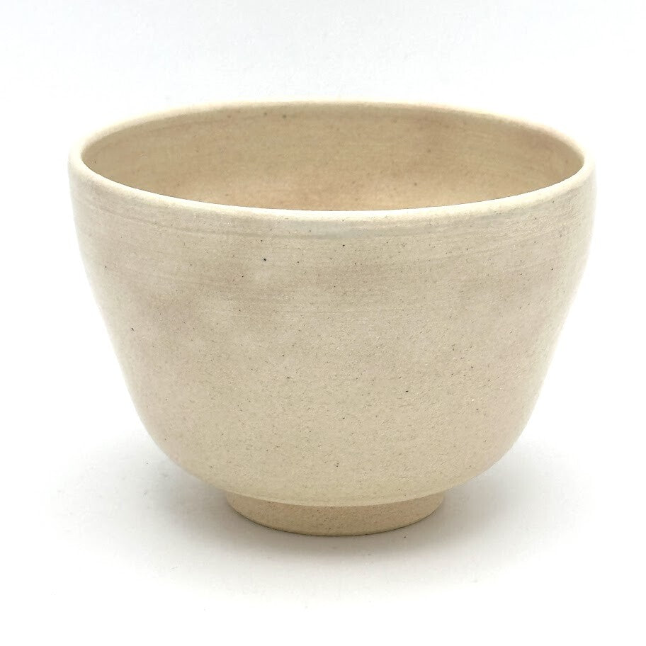 Reverse view of the Take bamboo Kyo Ware chawan showing its simple rounded form and softly textured beige glaze
