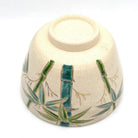 Underside view of the Take bamboo Kyo Ware chawan showing its ceramic foot and hand-painted bamboo decoration