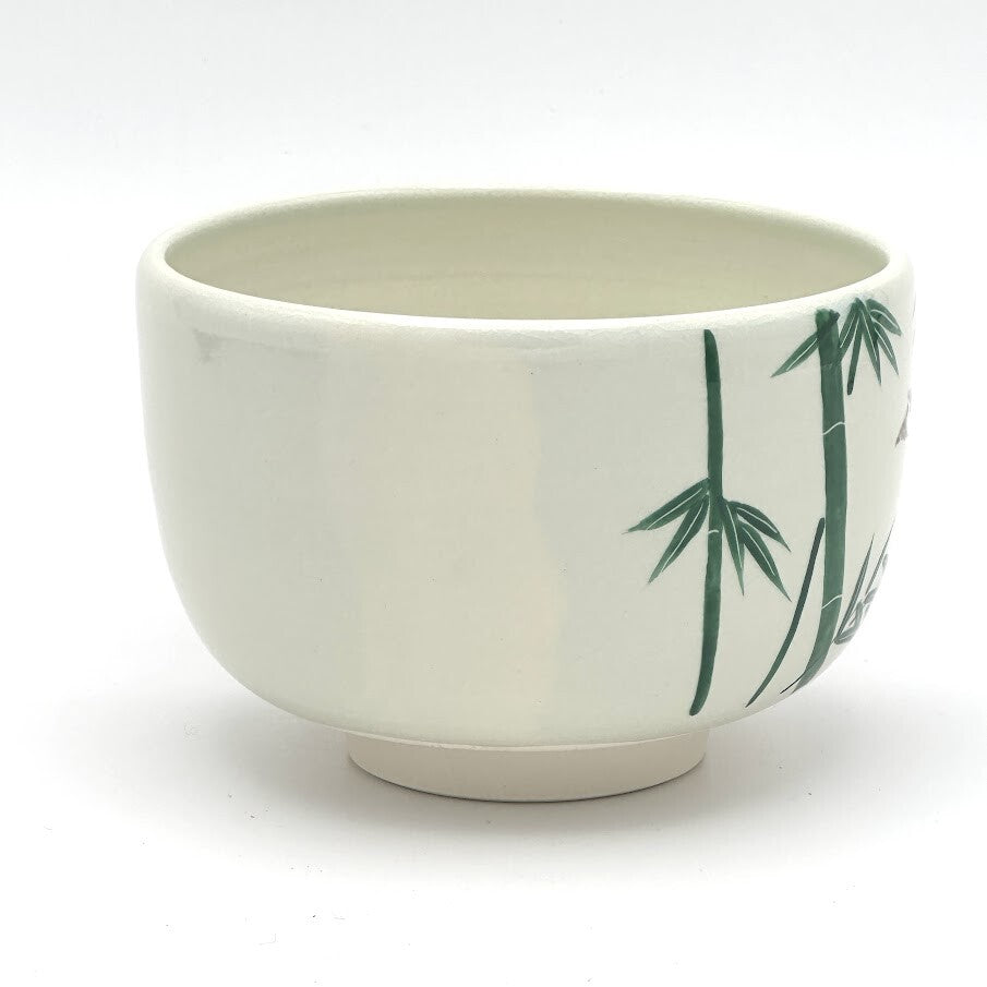 Side view of the Kyo Ware chawan showing hand-painted green bamboo against the warm ivory ceramic surface