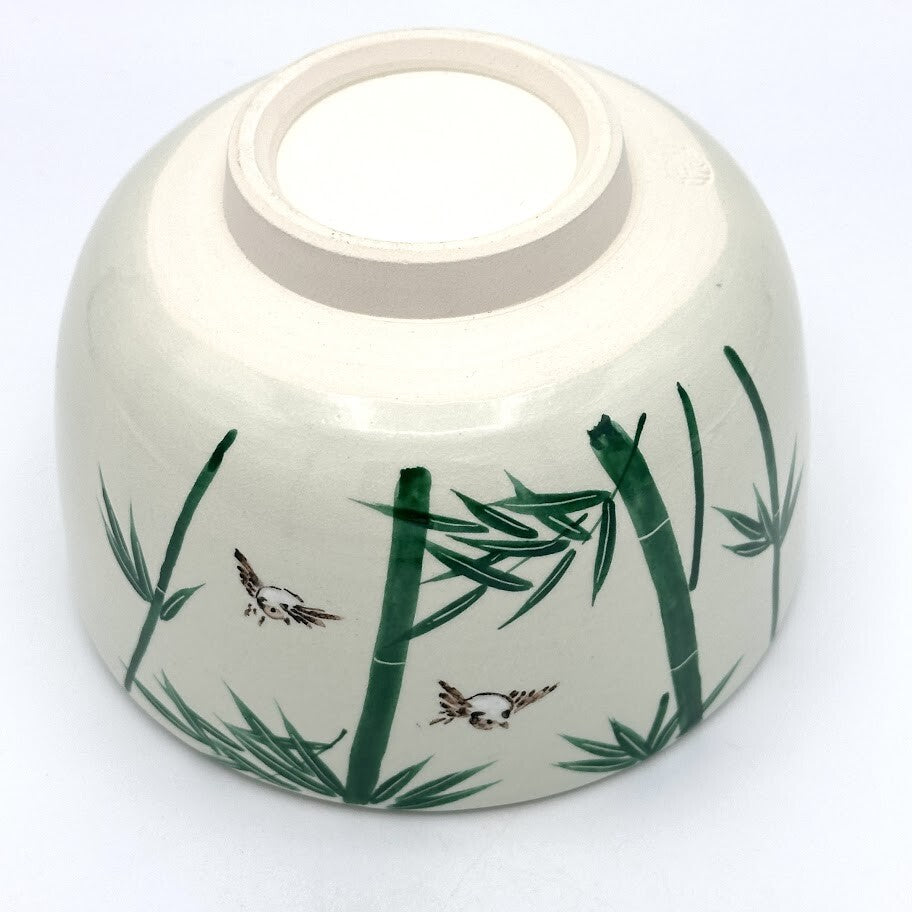 Underside view of the Take Suzume Kyo Ware matcha bowl showing its ceramic foot and hand-painted bamboo and sparrow decoration