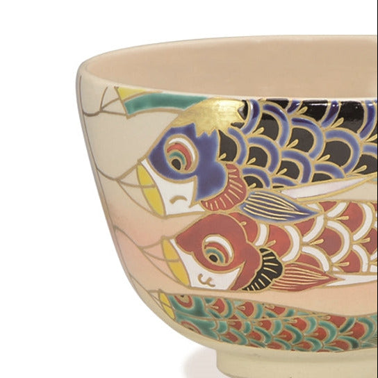 Ceramic bowl with colorful fish design on a white background