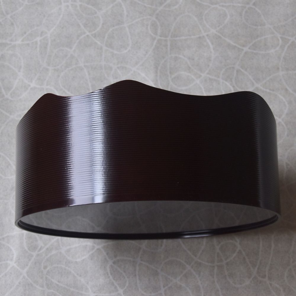 Black wall-mounted light fixture on a textured gray wall