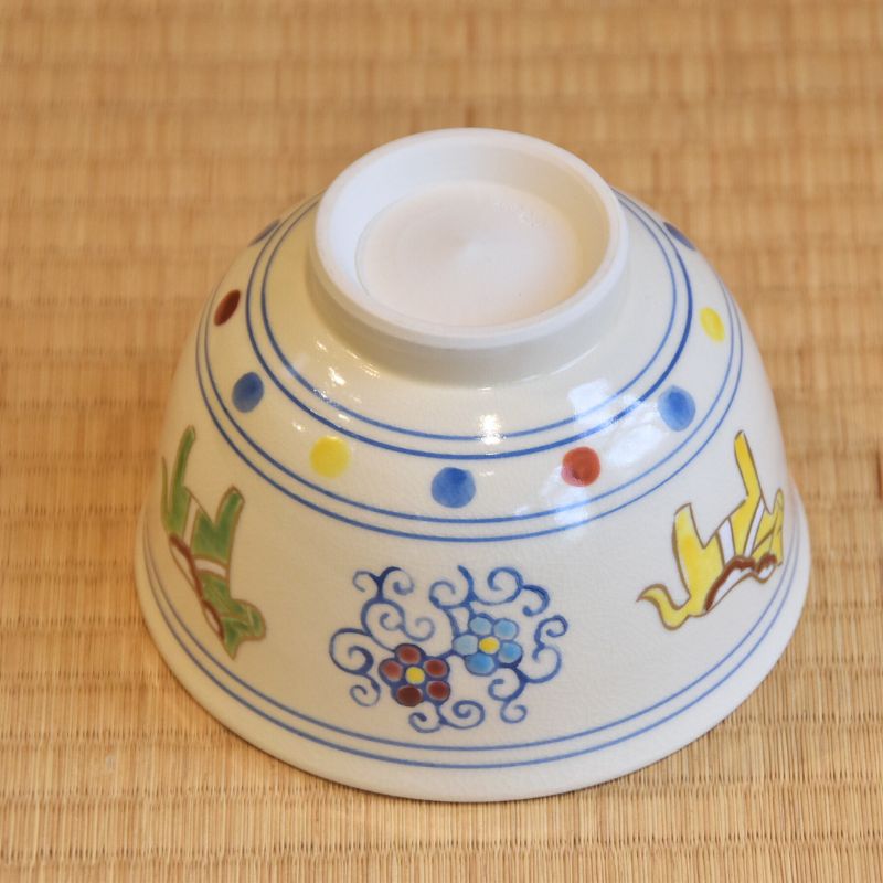 Angled underside view of the zodiac horse matcha bowl showing its raised foot, blue linework, and exterior decoration.